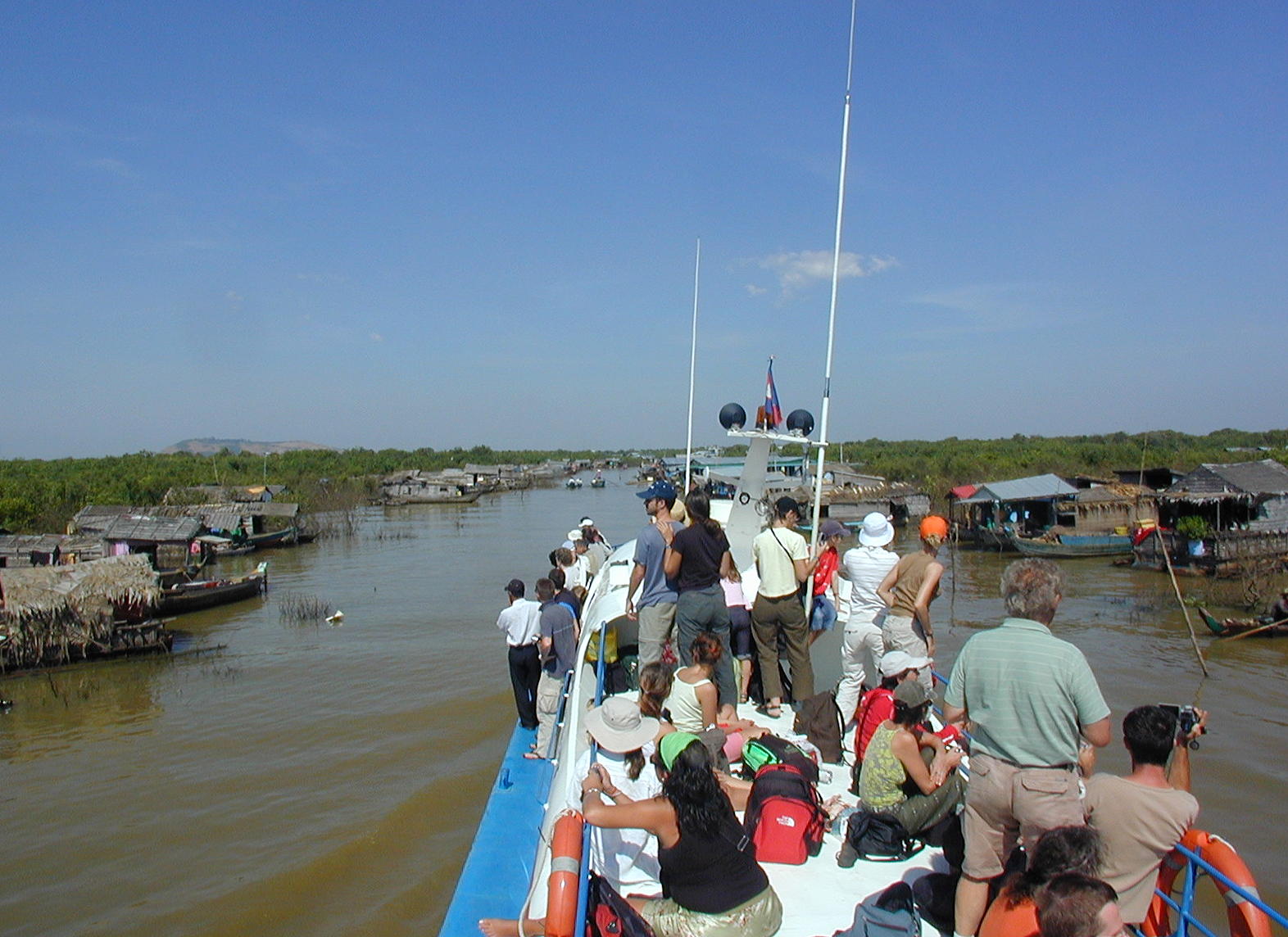 Weaving through the floating village to the harbor