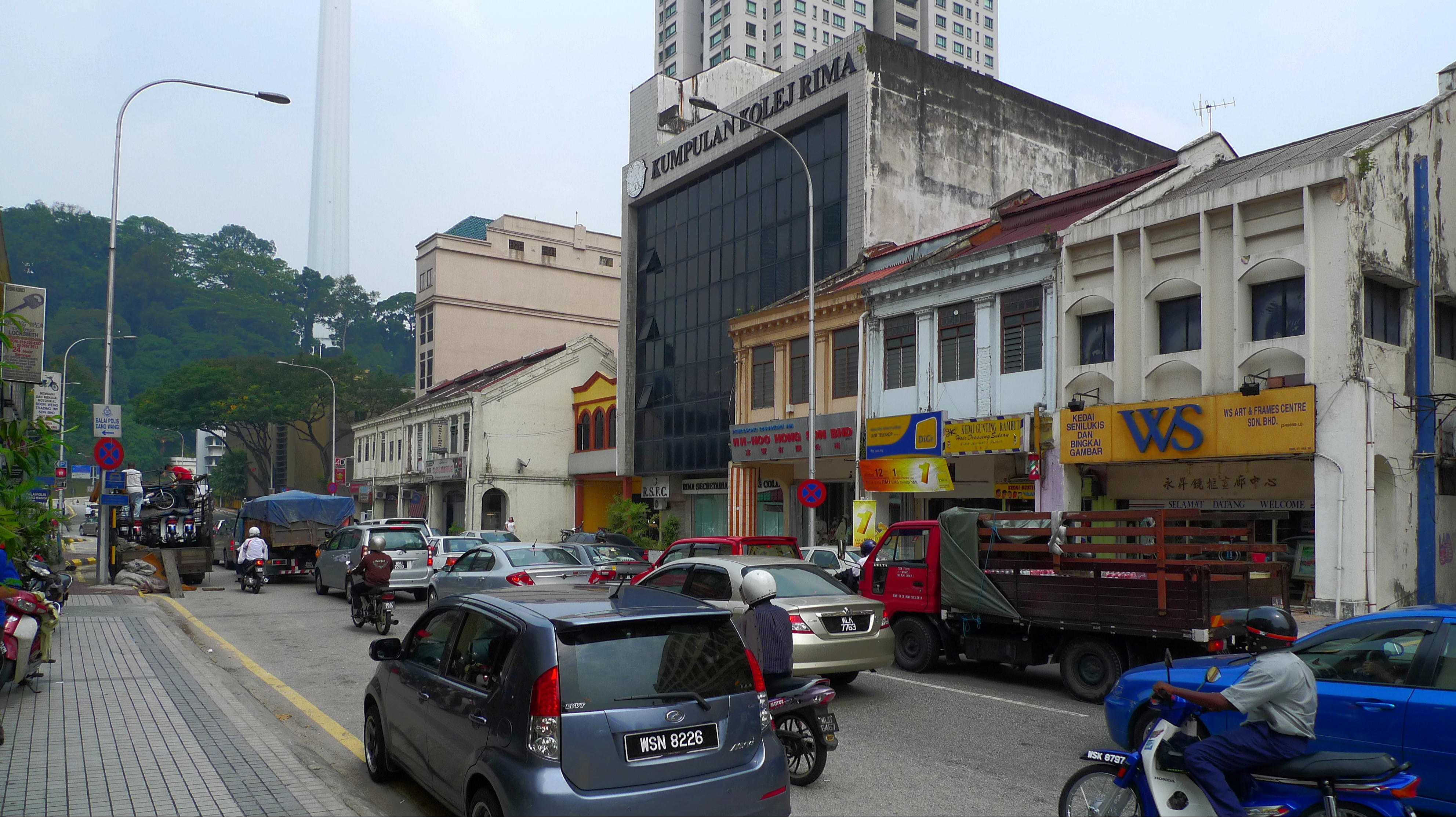 Kuala Lumpur, with a modern tower overlooking an older part of the city